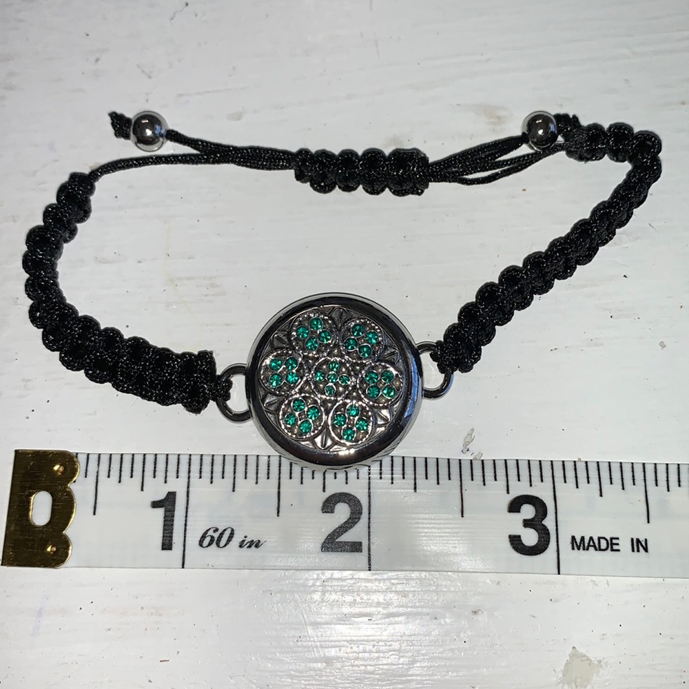 Adjustable braided black cord bracelet with one interchangeable snaps.  NWOT